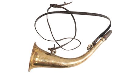 a brass horn with a leather strap on it