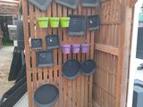 many pots and pans hanging on a wooden wall
