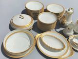 a lot of white and gold plates and cups