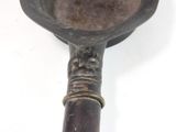 a metal spoon with a handle on a white surface