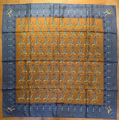 an orange and blue silk scarf with a pattern of birds on it