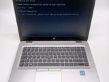 a laptop with a blue screen sitting on a white table