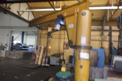 a picture of a man working on a crane in a building