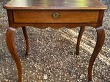 a small table with a drawer on top of it