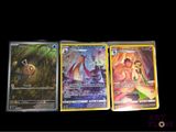 three different pokemon cards sitting on top of each other on a table