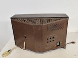 a brown television sitting on top of a white table