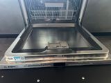 an empty dishwasher sitting on top of a counter in a kitchen