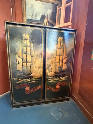 painting of two tall ships in a room with a blue floor