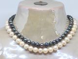 two strands of black and white pearls are on a mannequin