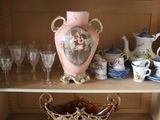 a shelf with a vase, cups, glasses and other items on it