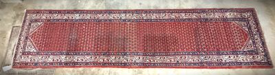 rug on the floor is red and white with a pattern on it