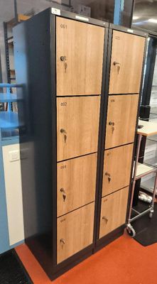 a tall wooden locker in the middle of a room