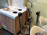 two chairs and a table in a room with a refrigerator
