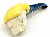 a yellow and blue pipe sitting on top of a white table