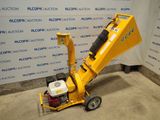 a close up of a small yellow machine on a concrete floor