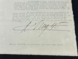 an old document with a signature on it sitting on top of a table