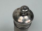 a silver container with a lid sitting on a table