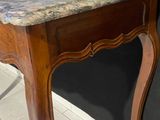 a table with a marble top on it in a room