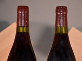 two bottles of wine that are sitting on a table