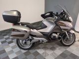 motorcycle parked in a room with a checkered floor and a white wall