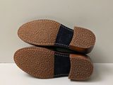 pair of men ' s blue and brown slippers on a white surface