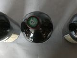 three bottles of wine that are sitting on a table