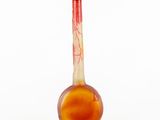 a glass vase with a red and white design on it