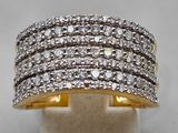 a gold and white diamond ring on a display stand