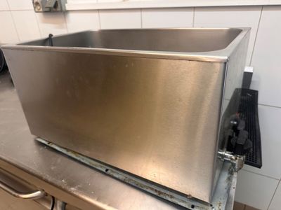 a stainless steel sink sitting on a counter in a kitchen