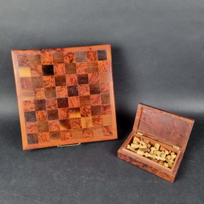 two wooden chess pieces in a wooden box on a black background