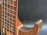 a close up of a guitar with a wooden body and strings