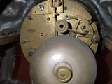a close up of a clock with a metal ball in it