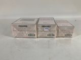 three boxes of soap sitting on top of a white table