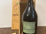 a bottle of wine on a table next to a wooden box