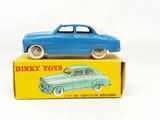 a blue toy car sitting on top of a yellow box