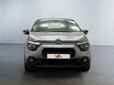 the front of a silver citrole parked in a white room