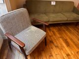 a couch and a chair in a room with wood floors