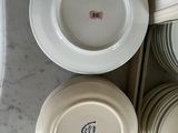 several plates and bowls are stacked on a counter top