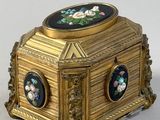 a gold box with a picture of flowers on it