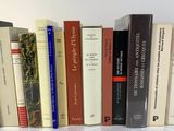 a lot of books that are lined up on a table