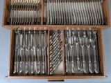 a wooden box with silverware in it on a table
