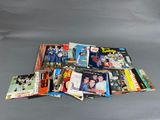 a pile of comics and books sitting on top of a table