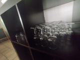 a black cabinet with a bunch of empty wine glasses on it