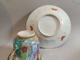 a cup and saucer sitting next to each other on a table