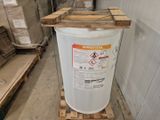 a white barrel sitting on top of a pallet in a warehouse