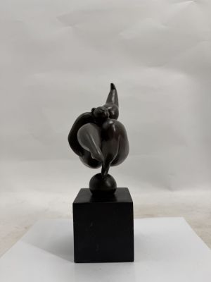 statue of an elephant on a black base on a white surface