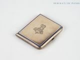a small silver box with a picture of a horse on it
