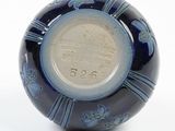 a blue and white vase with a blue design on it