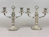 pair of silver plated candelabs with candlesticks on stands