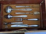 a lot of silver spoons and spoon spoons in a box